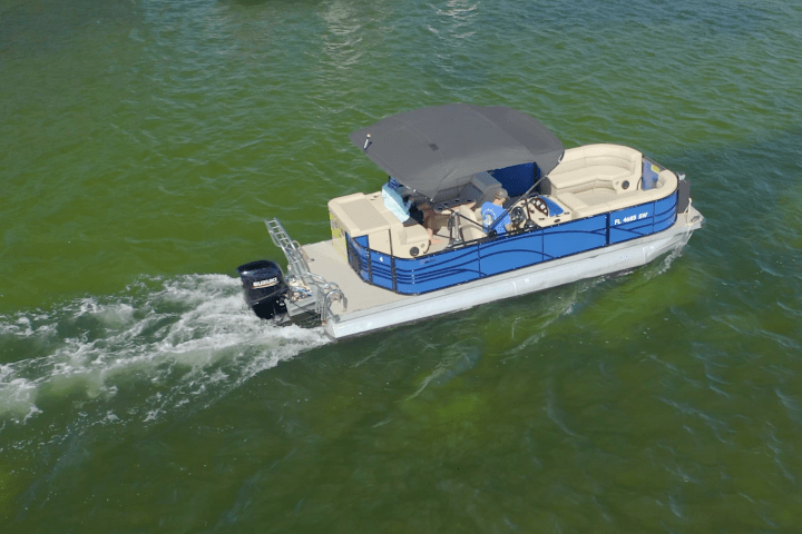 a pontoon boat in a body of water
