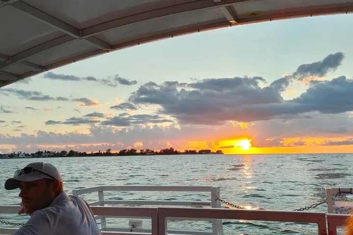 a person sitting on a bench next to a body of water