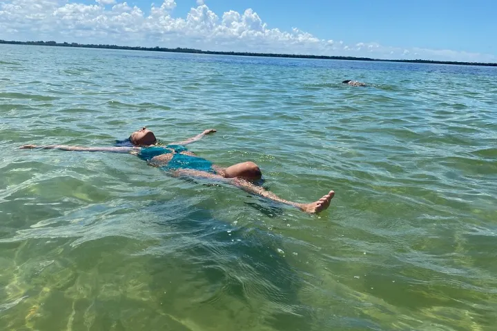 a person riding a surf board on a body of water