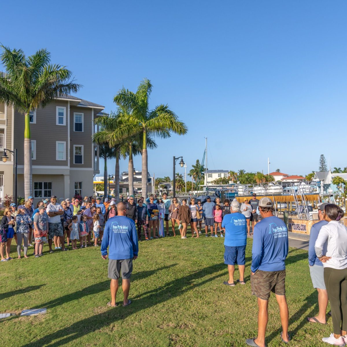 a group of people that are standing in the grass